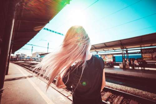 Happy Girl Enjoying Free Time & Waiting for Train