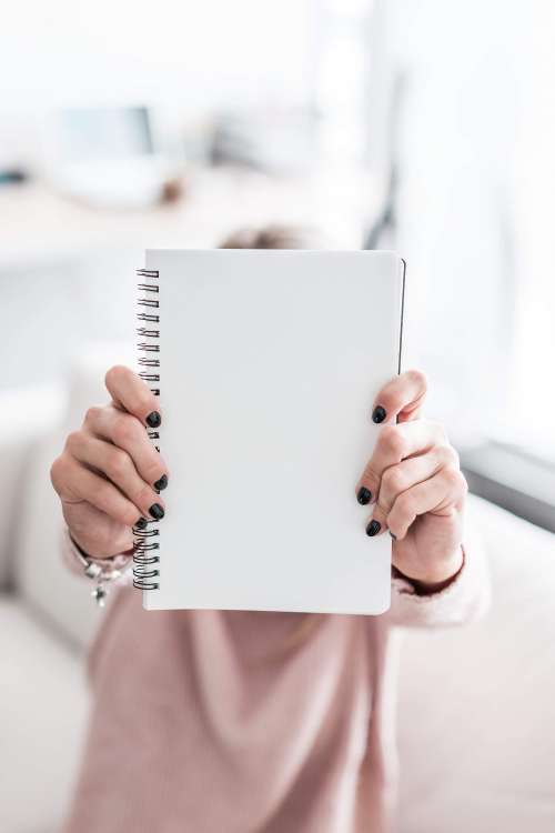Woman Holding Blank Notebook