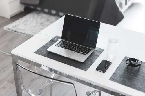 Minimalistic White Desk Home Office Laptop and Smartphone