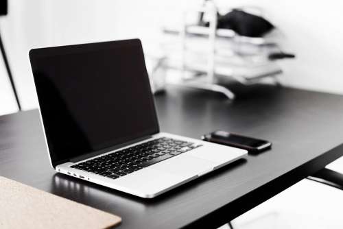 Modern Laptop and Smartphone on Black Desk