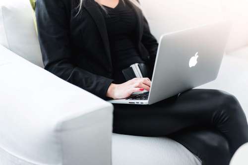 Woman Entrepreneur Working on Silver Laptop