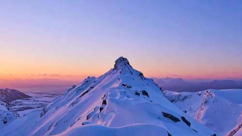Snowy Mountain Peak with Sunrise Glow