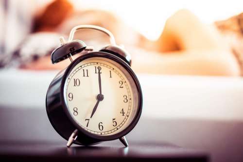 Vintage Alarm Clock and Sleeping Woman