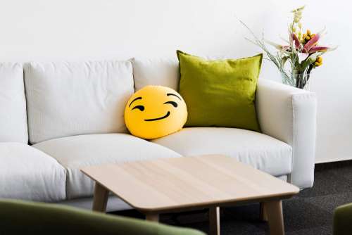 White Office Couch with Funny Emoji Pillow