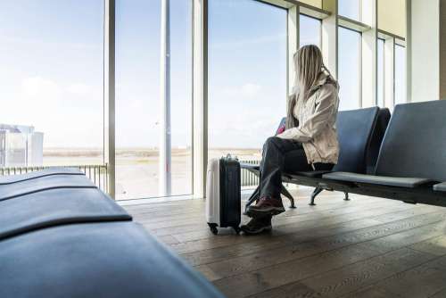 Woman Traveler Waiting at Icelandic Airport