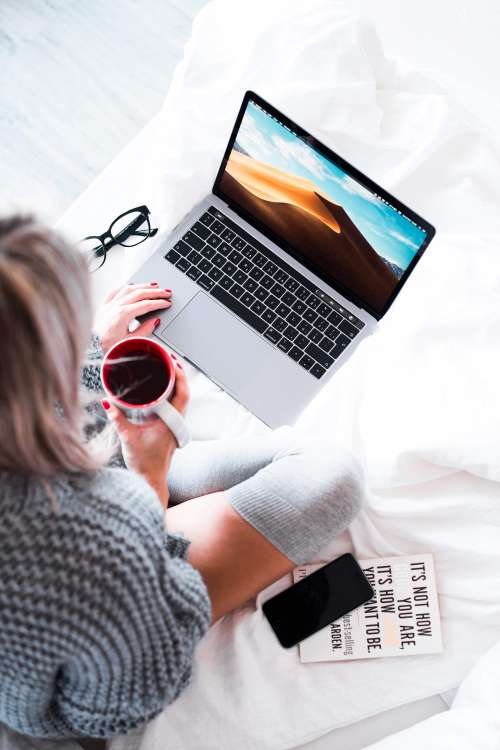 Woman Using Her Laptop in Bed