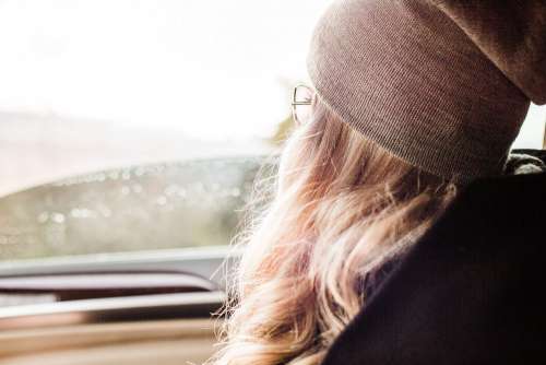 Young & Beautiful Blonde Girl Looking Out of Car Window