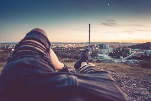 Young Man Chilling and Enjoying Evening Cityscape View