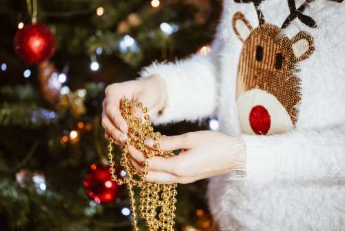 Young Woman Decorating Christmas Tree
