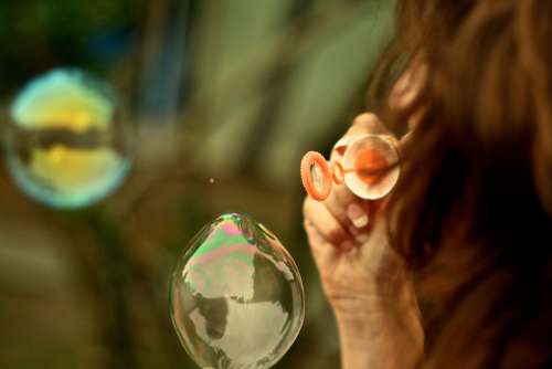 Young Woman Making Bubbles