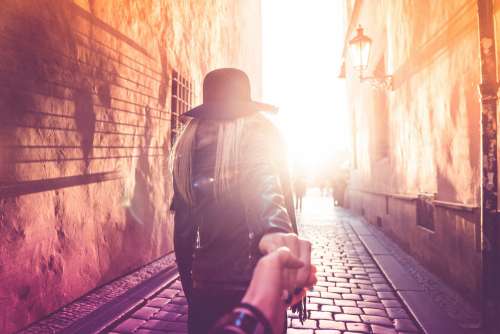 Young Woman Presents Follow Me To Pose in Prague Streets