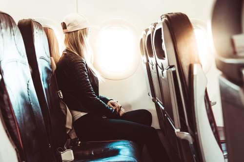Young Woman Traveling by Airplane