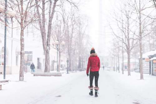 Young Woman Walking Alone in The Park in Snowy Weather