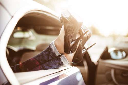 Young Woman With High Heels in Car Transport Limousine Service