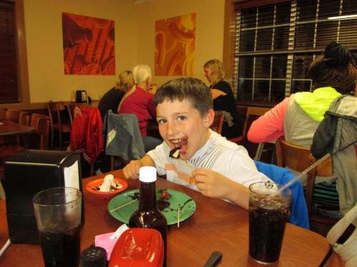 Boy Eating Chocolate Fast Food Restaurant