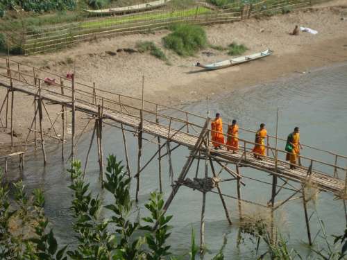 Buddhist Monks Crossing Bridge Laos