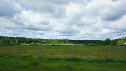 Finnish On The Road Green Fields Forest Clouds