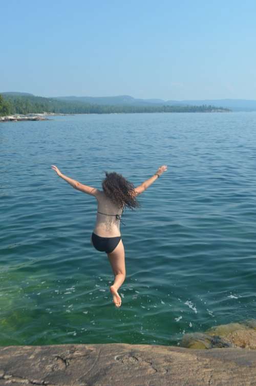 Girl Jumping Into Water Swimming Rock Jump