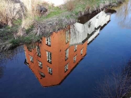 House Mirroring Blue Water