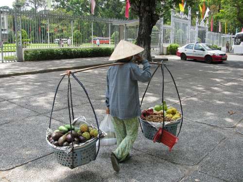 Indonesia Woman Working Carrying Fruit Baskets