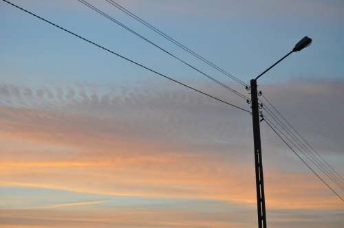 Lantern High-Voltage Line Sunset Sky Clouds