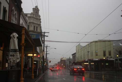 Rain Street Shops Wet Car Tram Lines