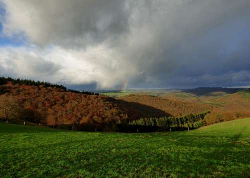 Rainbow Storm Threatening Sky Hills Landscape