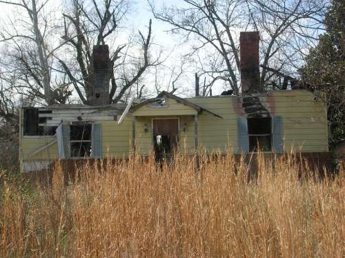 Shack Outside Yellow House Rundown Trailer Old