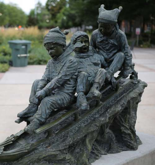 Statue Outside Children Sled Outdoors Bronze