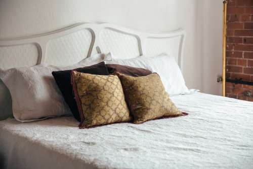 Bedroom Bed With Brown Throw Pillows Photo