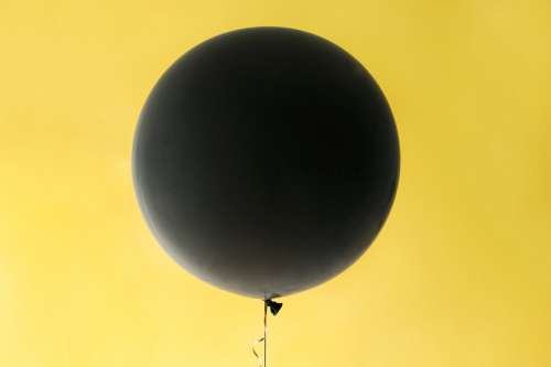 Black Balloon On Yellow Photo