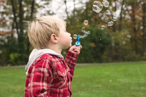 Boy Blowing Bubbles Photo