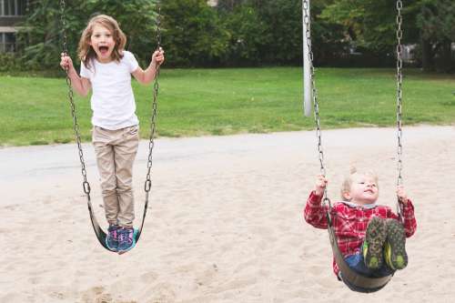 Brother & Sister On Swings Photo