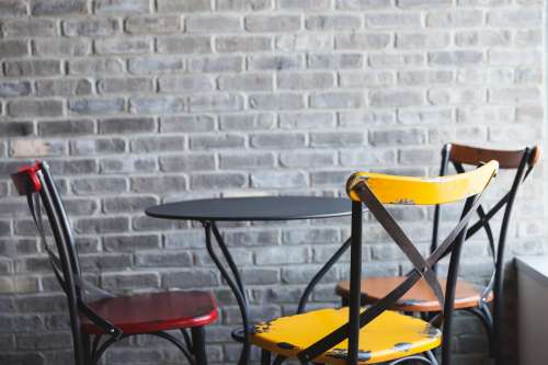Cafe Chairs And Brick Wall Photo