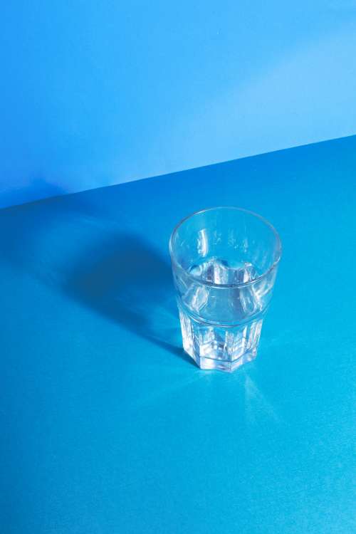 Clear Water Glass Reflecting On Blue Photo