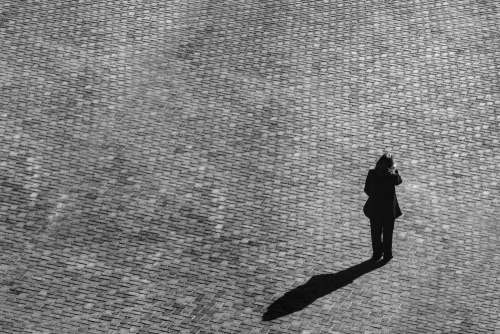 Cobblestone And Person With Shadow Photo