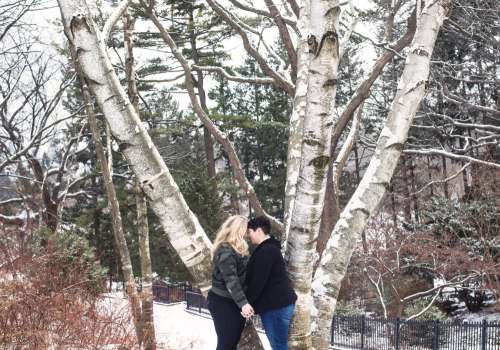 Couple Share A Moment Under Snow Covered Trees Photo