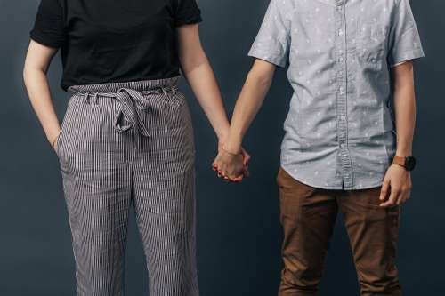 Couple Side By Side Holding Hands Photo