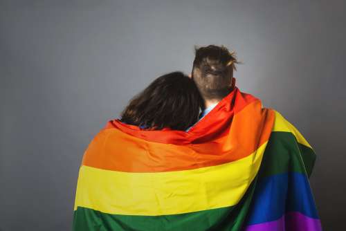 Couple Wrapped In Pride Flag Photo