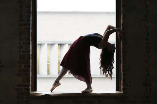 Dancer Bends Back In Window Photo