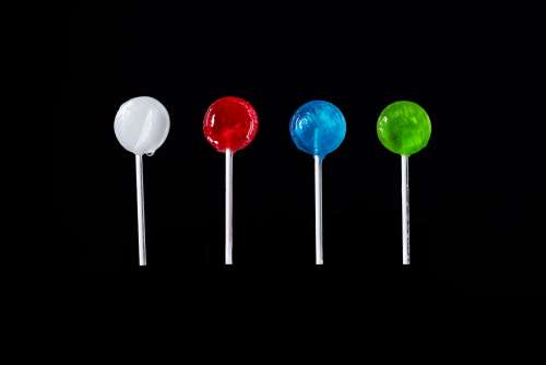 Different Colored Lollipops On Black Photo
