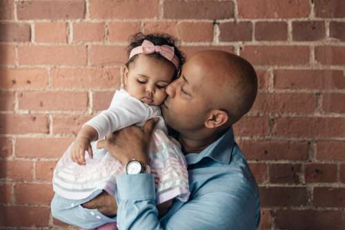 Father Gives Baby Daughter A Kiss Photo