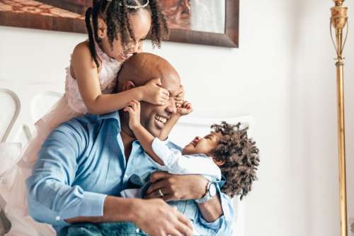 Father Plays With Son And Daughter Photo