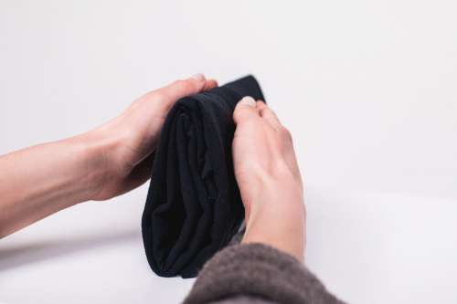 Folding Clothes Neatly To Save Space Photo