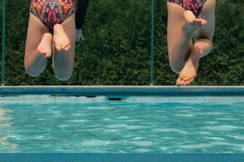 Friends Jump In Pool Together Photo