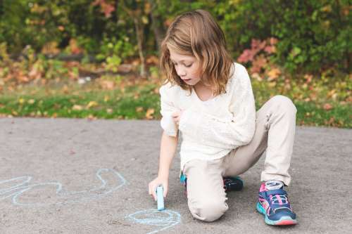 Girl Using Sidewalk Chalk Photo