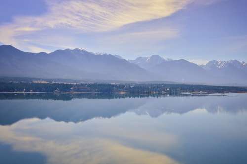 Glassy Lake Reflects Snow-Capped Mountains Photo