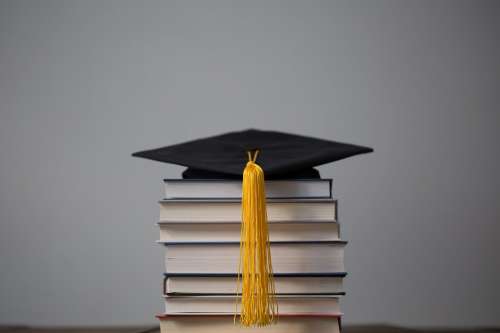 Graduation Cap On Top Of Books Photo