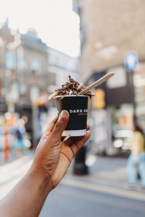 Hand Holding Cup Of Chocolatey Delicious Photo