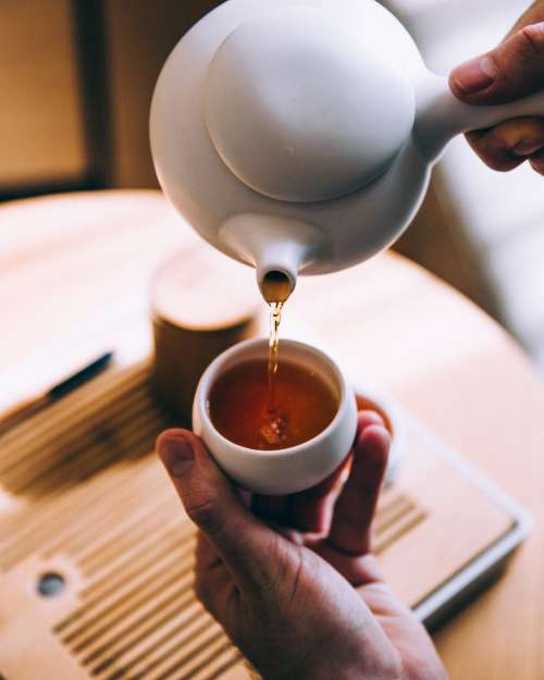 Hand Pouring Hot Tea Photo